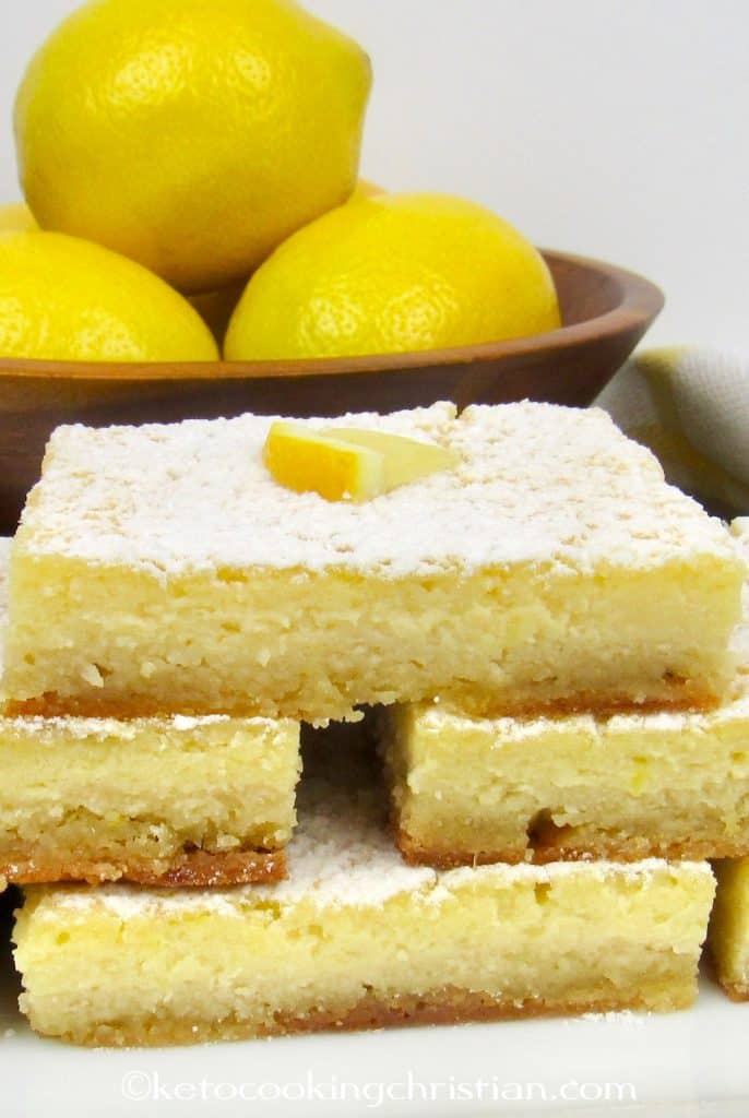 Lemon Bars stacked up on white plate