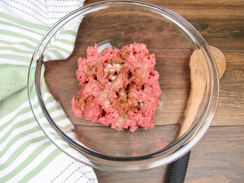 ground beef and spices in a mixing bowl