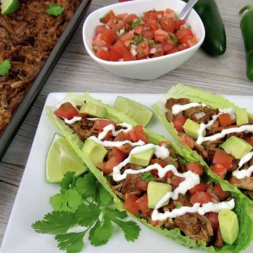 pork carnitas in lettuce wraps with salsa in background