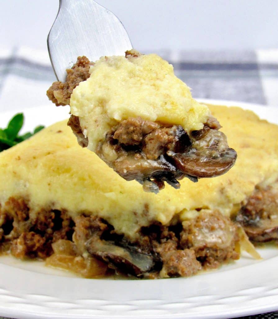 piece of Beef Stroganoff Casserole on white plate with fork holding up some