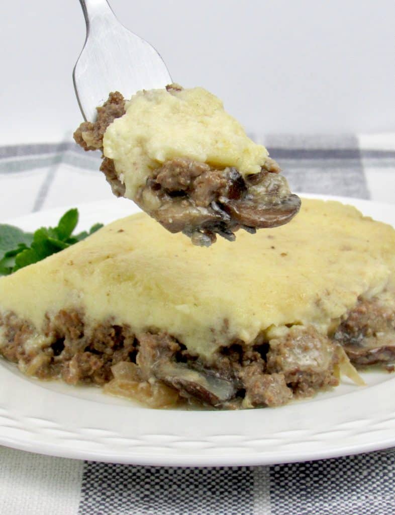 Keto and Low Carb Beef Stroganoff Casserole Slice on Plate with Bite on Held Fork