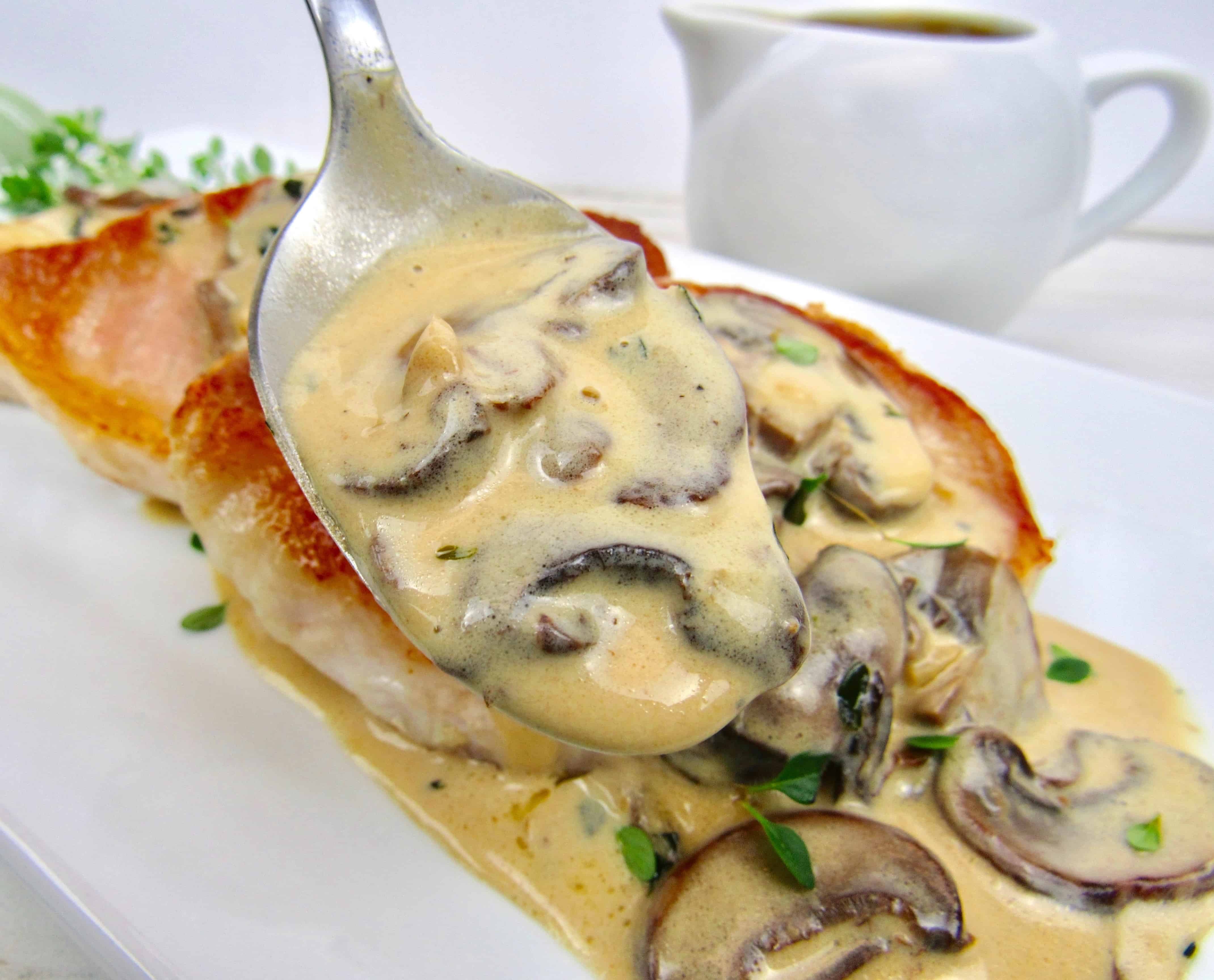 closeup of mushroom gravy held up in spoon