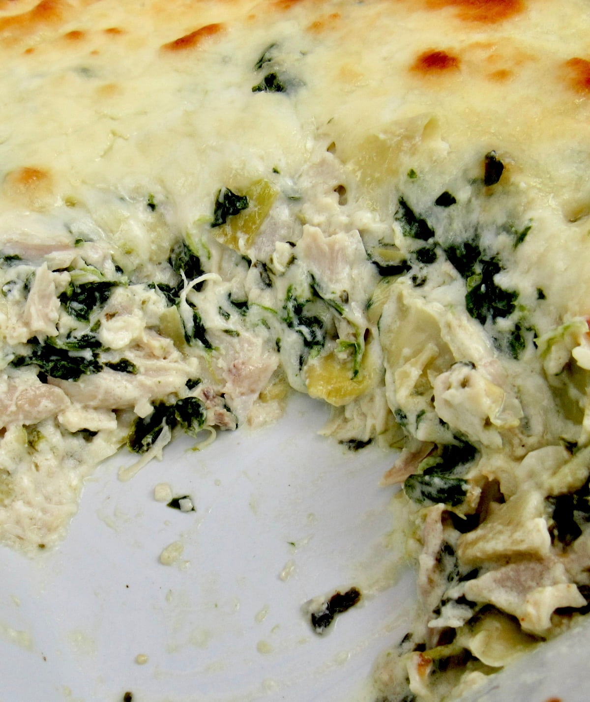 Spinach Artichoke Casserole with piece missing