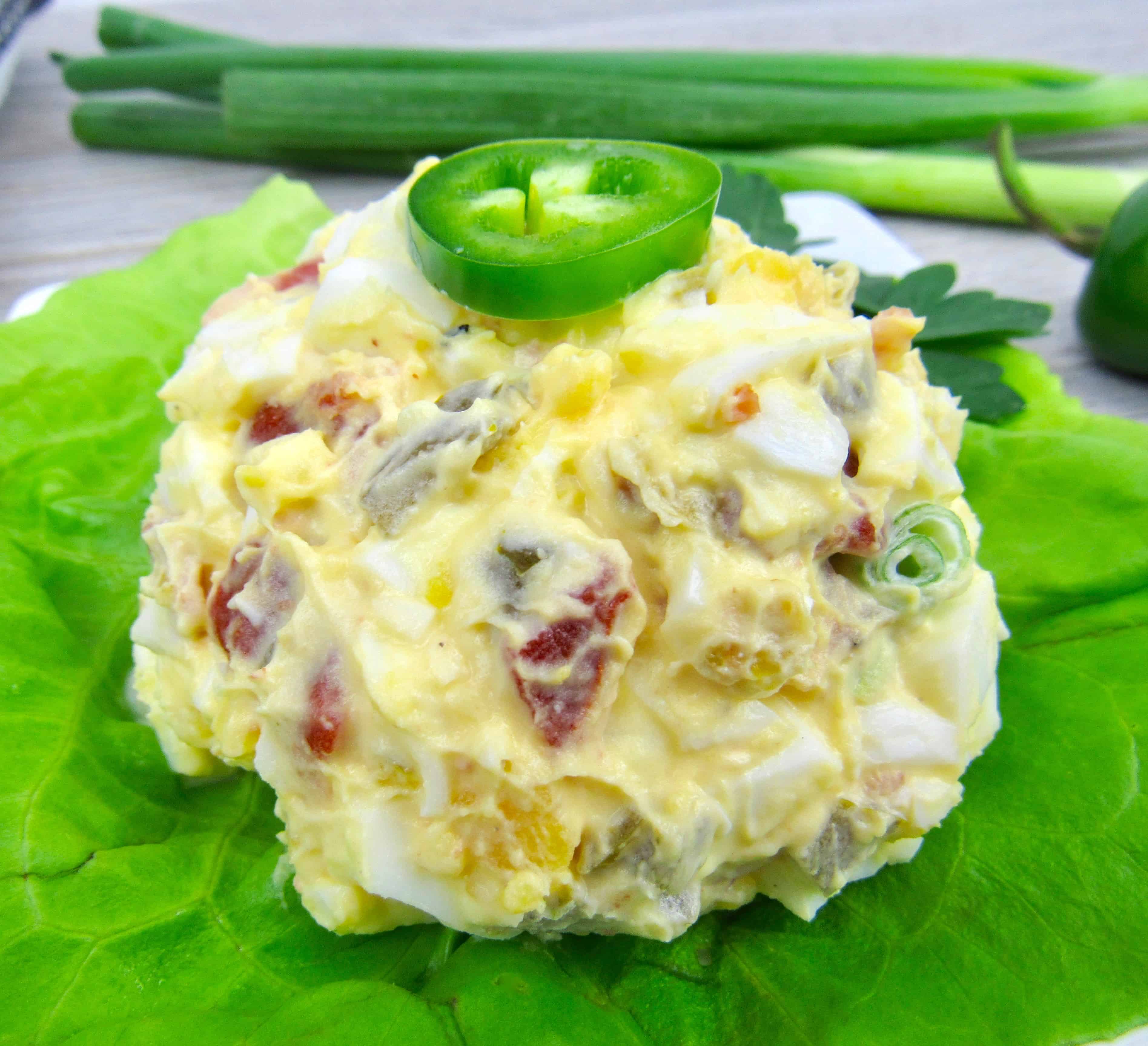 closeup of jalapeno popper egg salad on piece of lettuce on plate