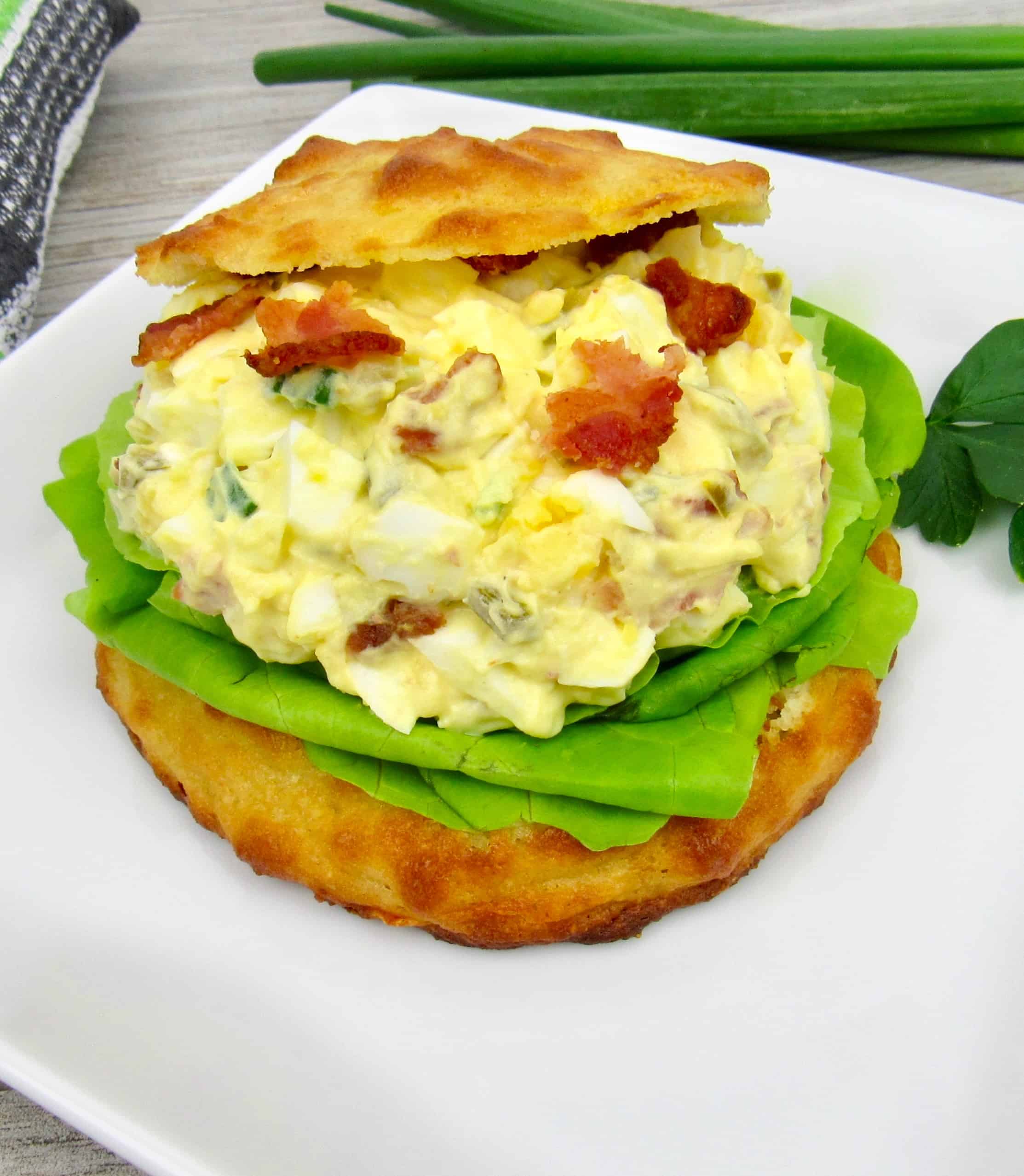 Jalapeno Popper Egg Salad on bun sitting on white plate
