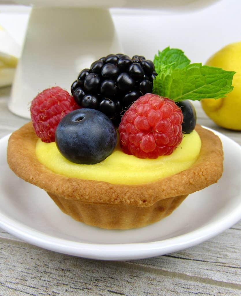 mini lemon tart with berries on top