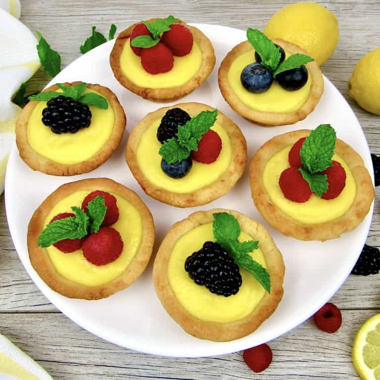 7 mini lemon curd tarts with berries on top