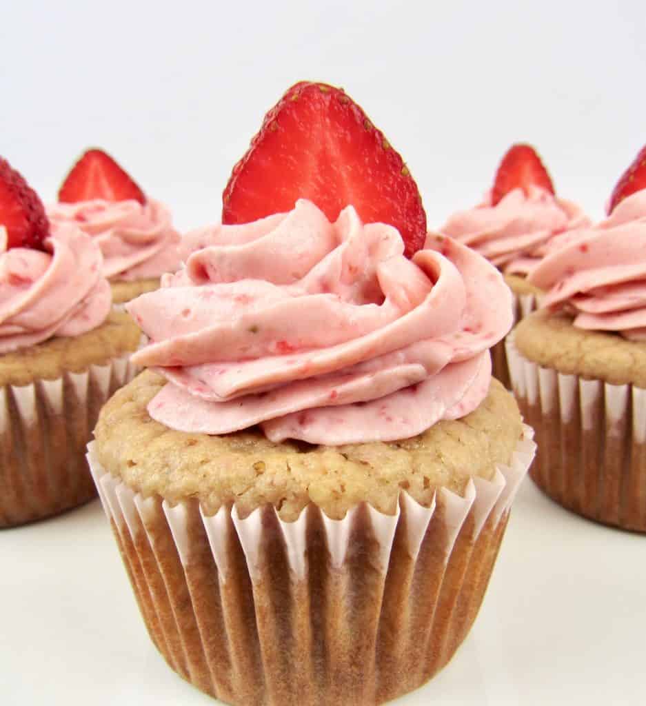 Strawberry Cupcakes with strawberry frosting and a slice of strawberry on top