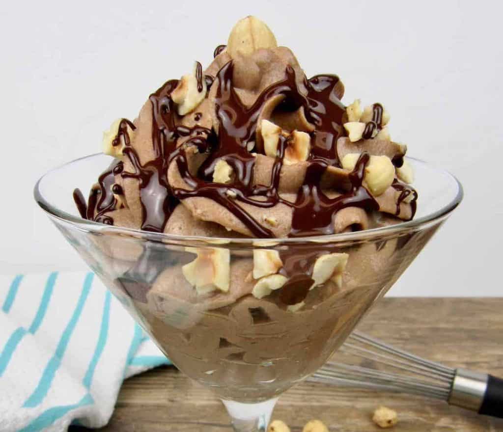 nutella chocolate mousse in martini glass with chocolate syrup and hazelnuts