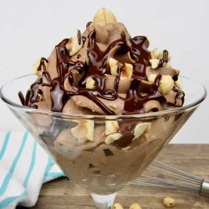 nutella chocolate mousse in martini glass with chocolate syrup and hazelnuts