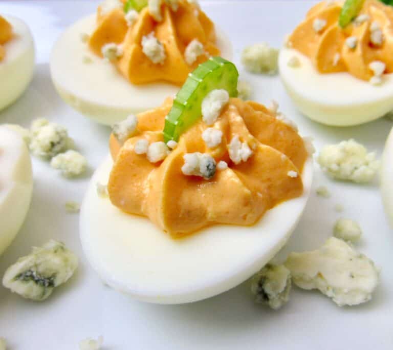 closeup of buffalo deviled eggs on white plate