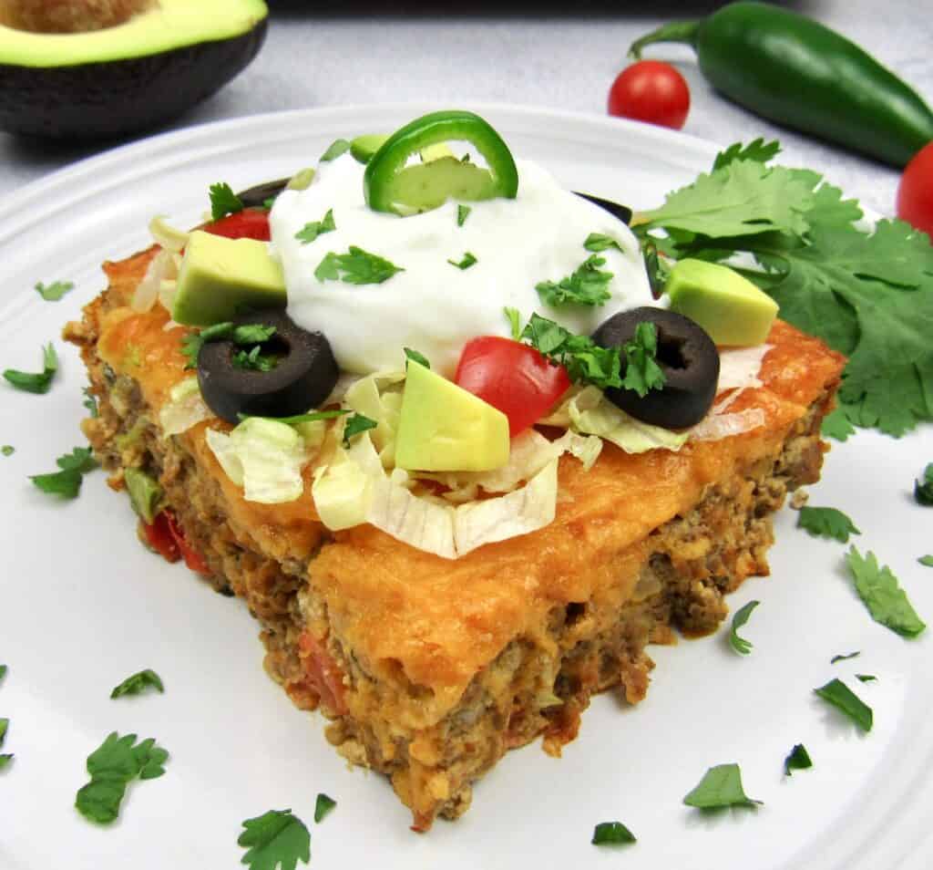 closeup slice of taco casserole with toppings