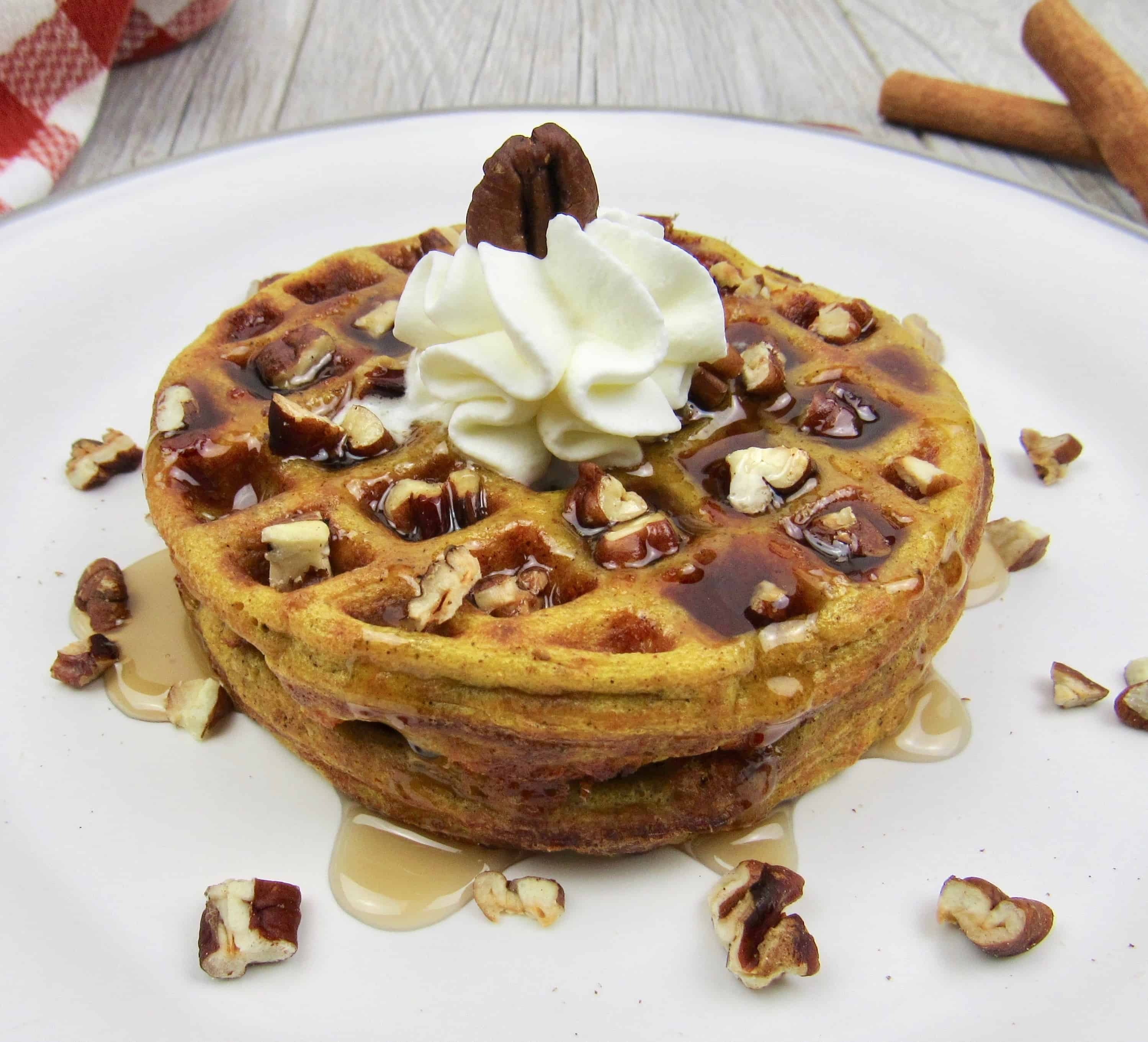 Keto Pumpkin Chaffles on plate with syrup and nuts