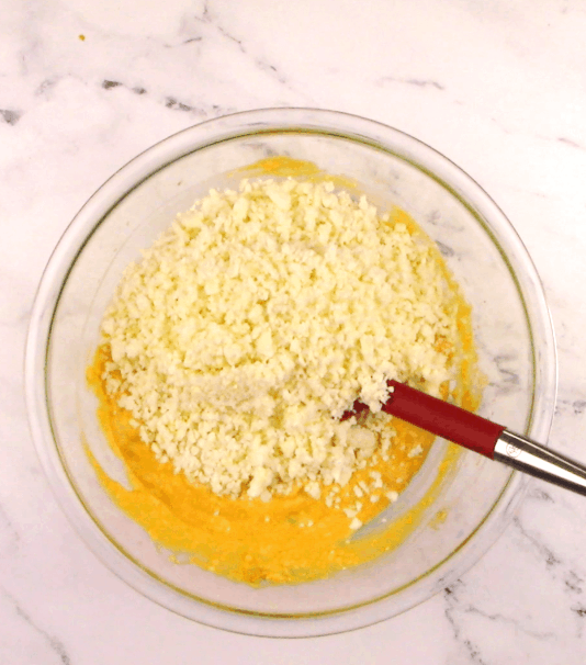 buffalo chicken casserole ingredients with cauliflower rice on top in bowl