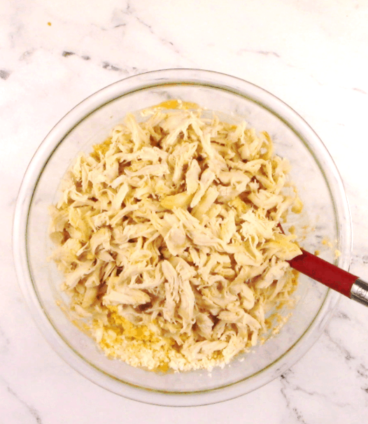 buffalo chicken casserole ingredients in glass bowl