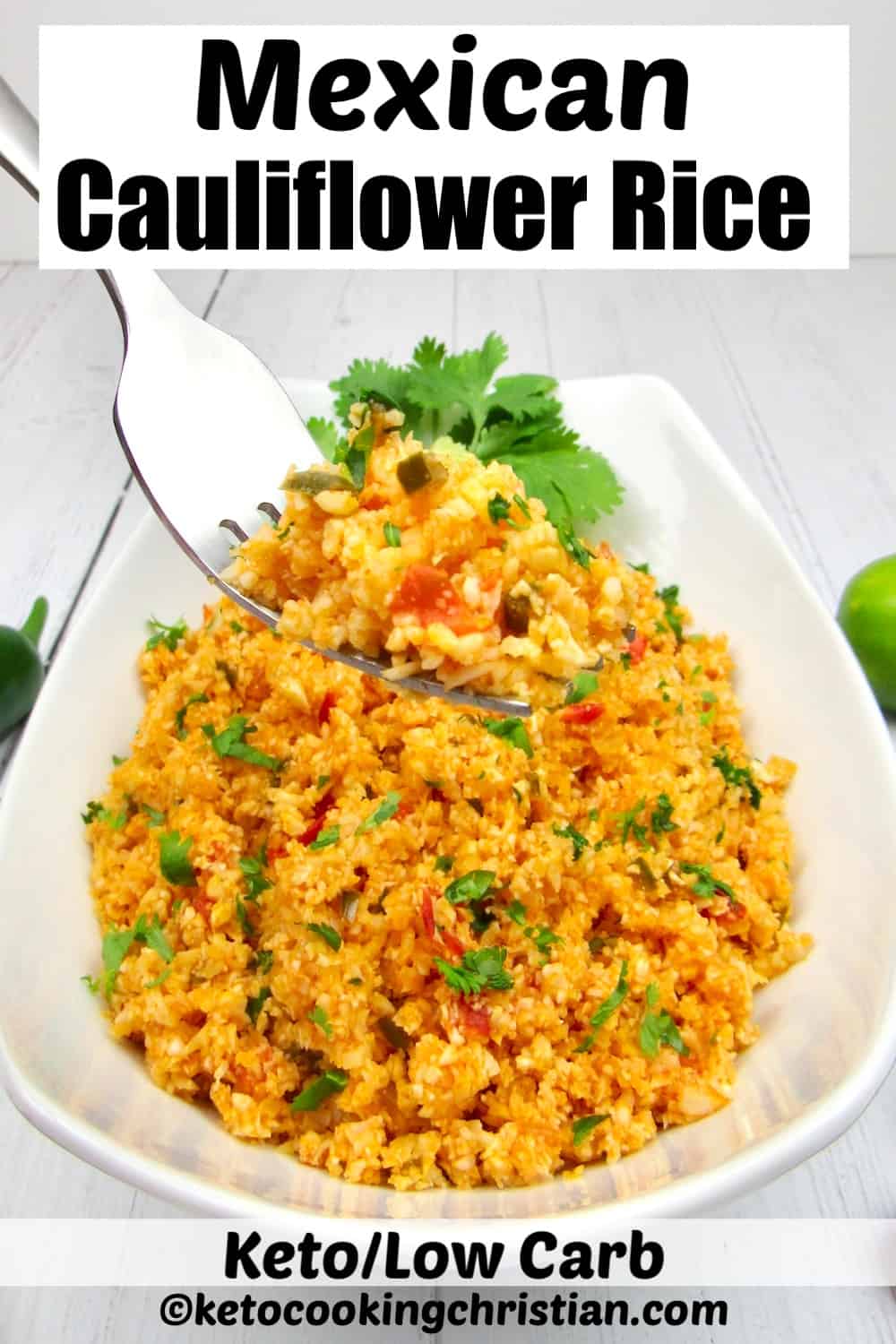 Mexican cauliflower rice in white bowl with fork lifting up some