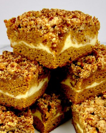 slices of pumpkin coffee cake stacked up on a square plate