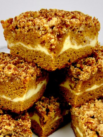 slices of pumpkin coffee cake stacked up on a square plate