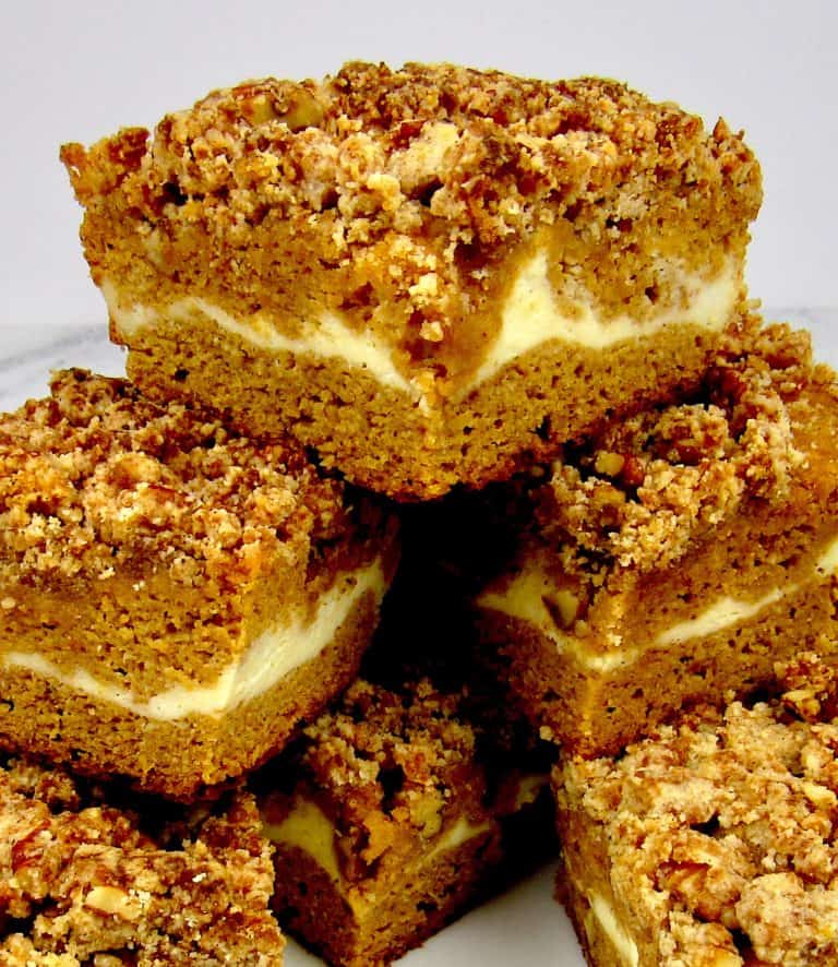 slices of pumpkin coffee cake stacked up on a square plate