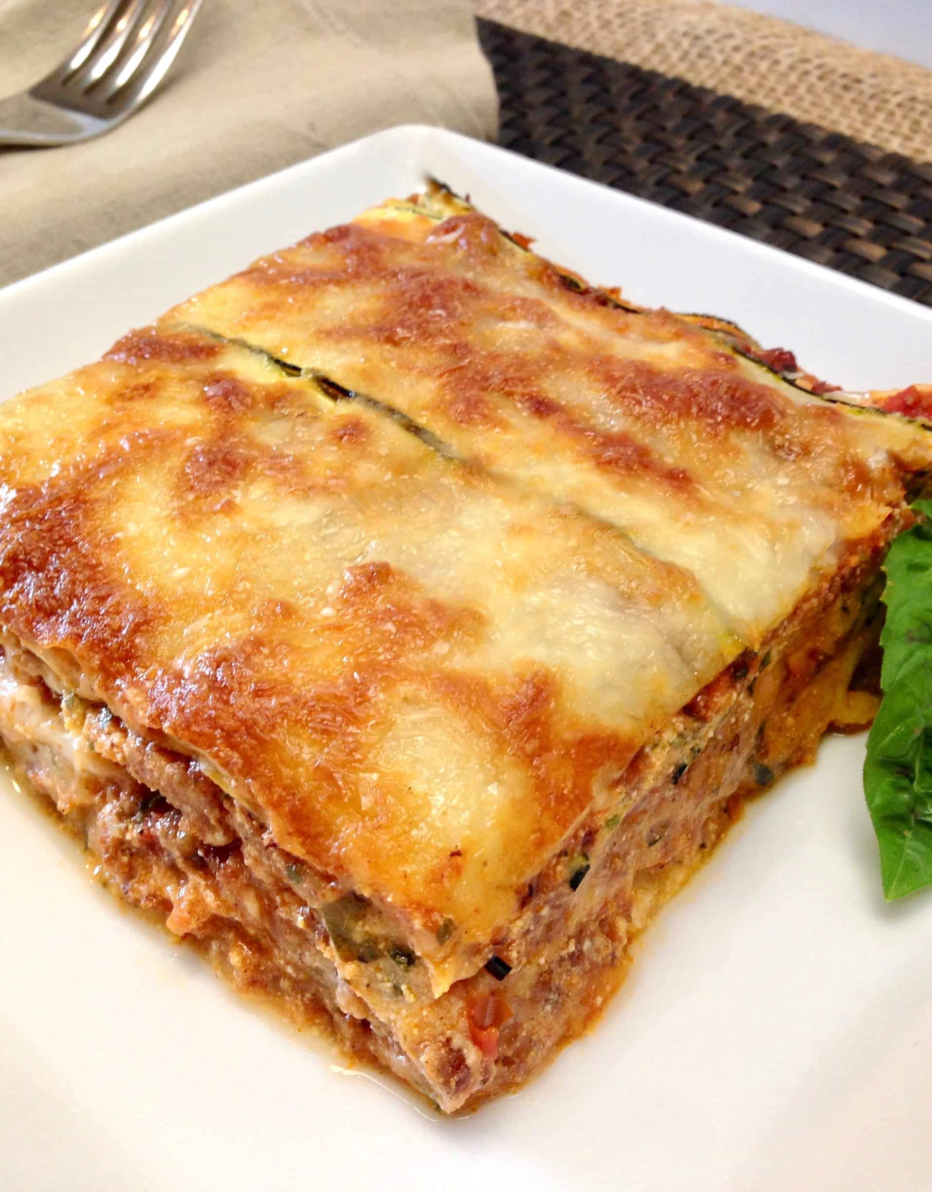 slice of zucchini lasagna with basil garnish on white plate