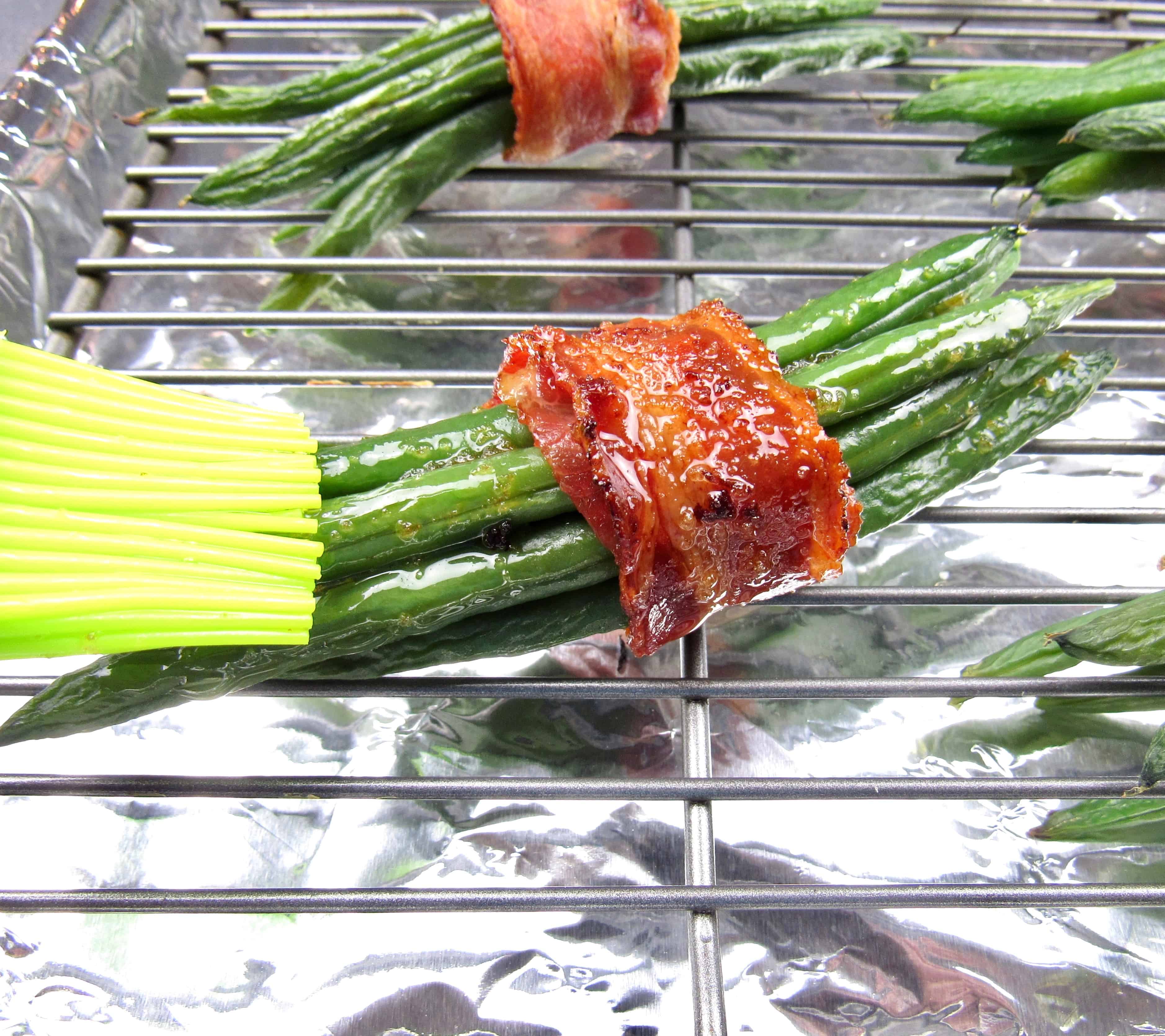 bacon wrapped green beans on baking rack brushed with oil