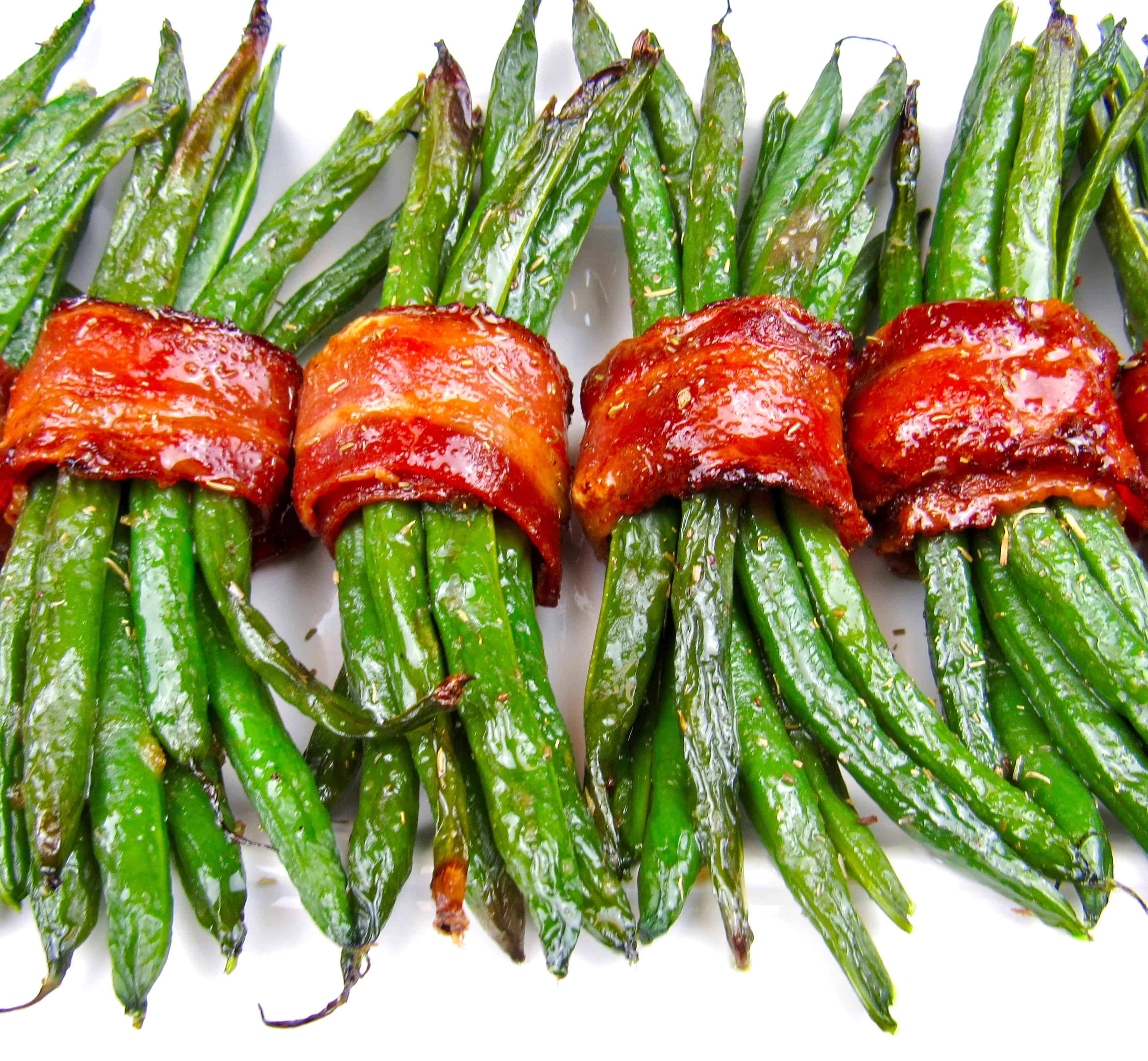 bacon wrapped green beans on white plate