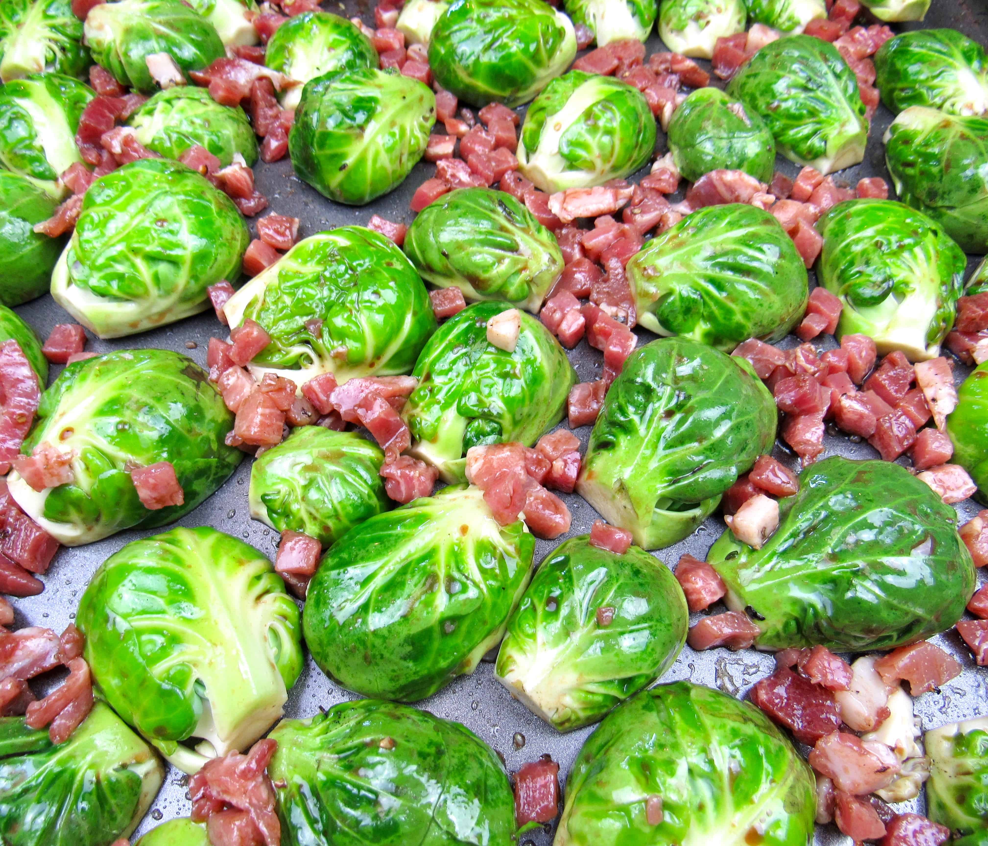 closeup of brussels sprouts on sheet pan with pancetta