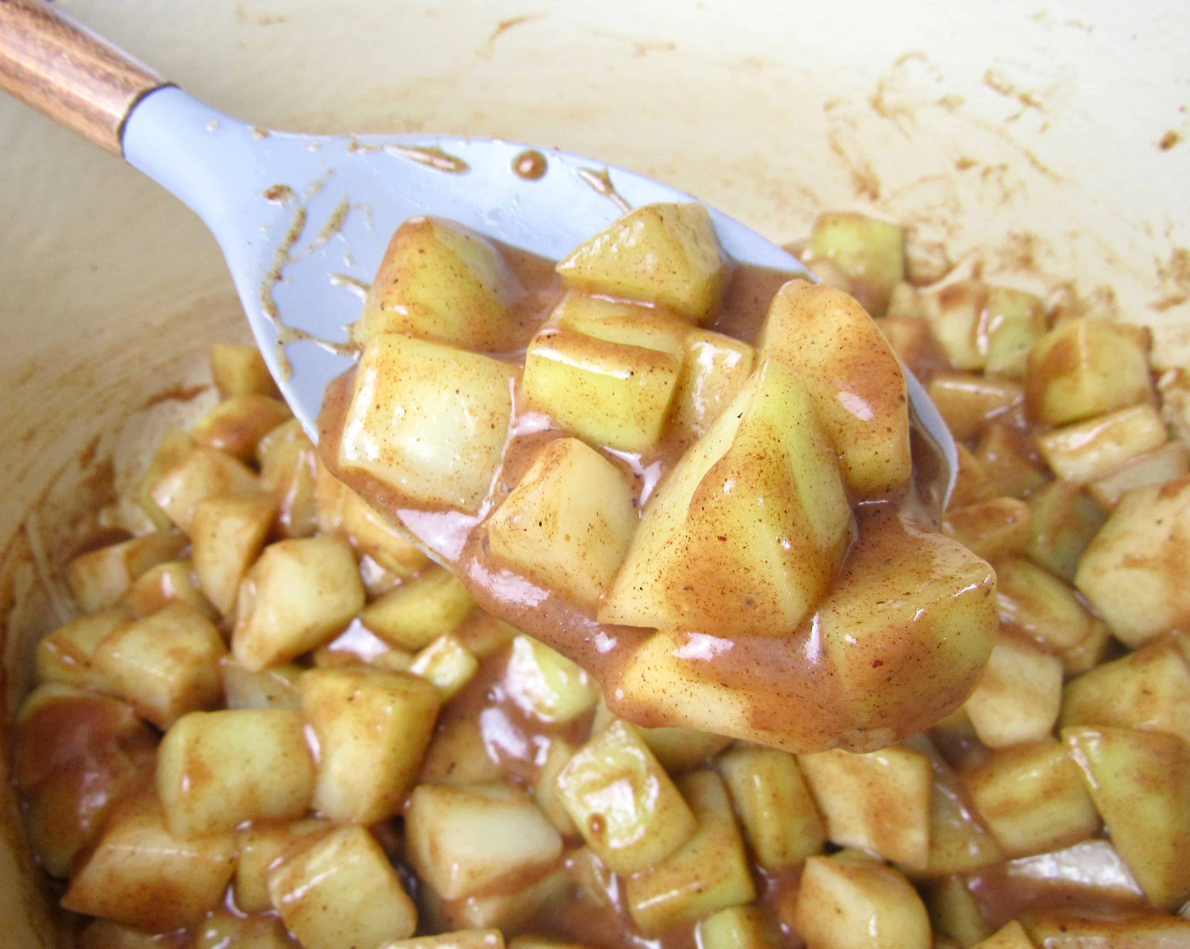 cooked chayote squash in pot with some in ladle