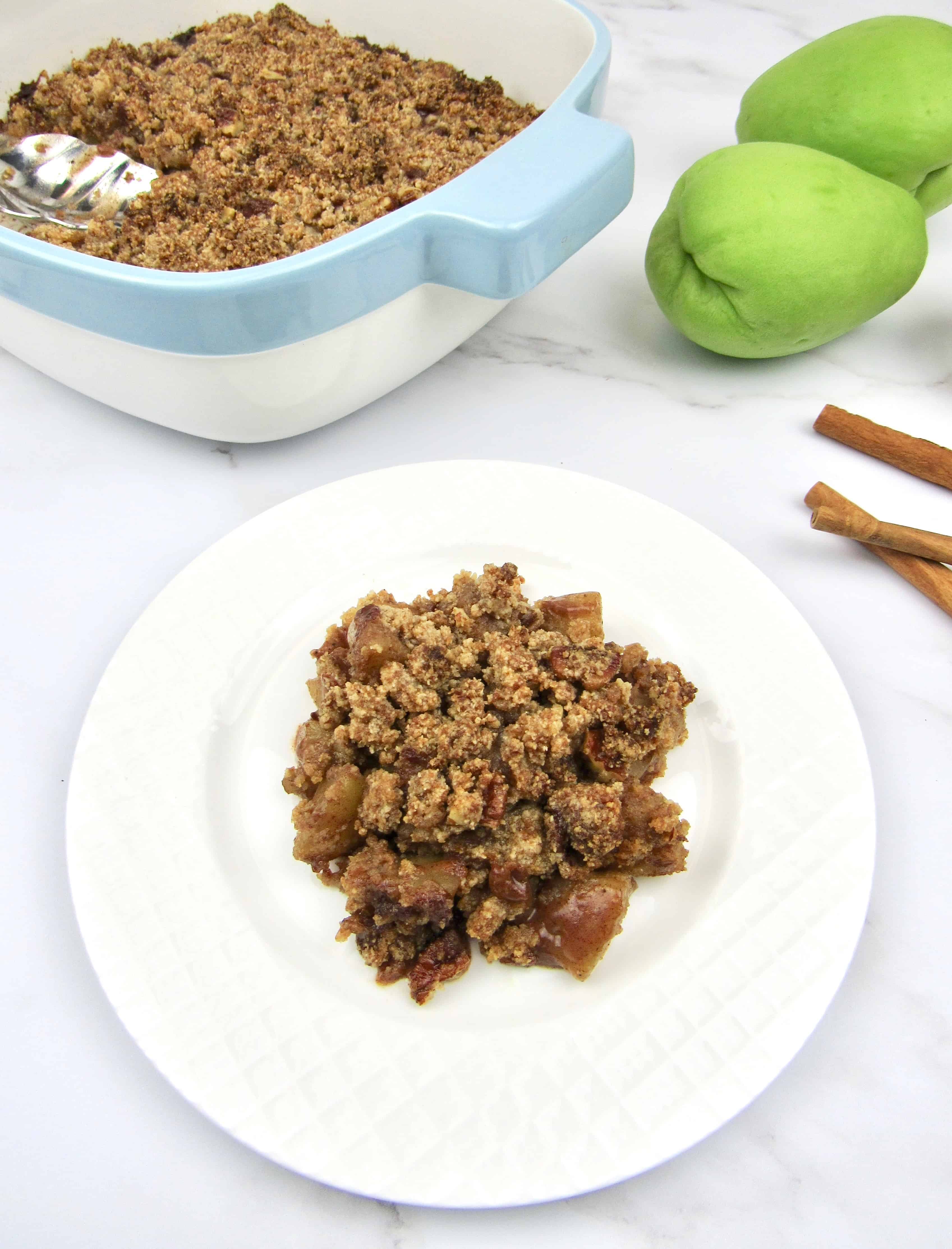 overhead view of mock apple crumble on white plate chayote squash and casserole in background