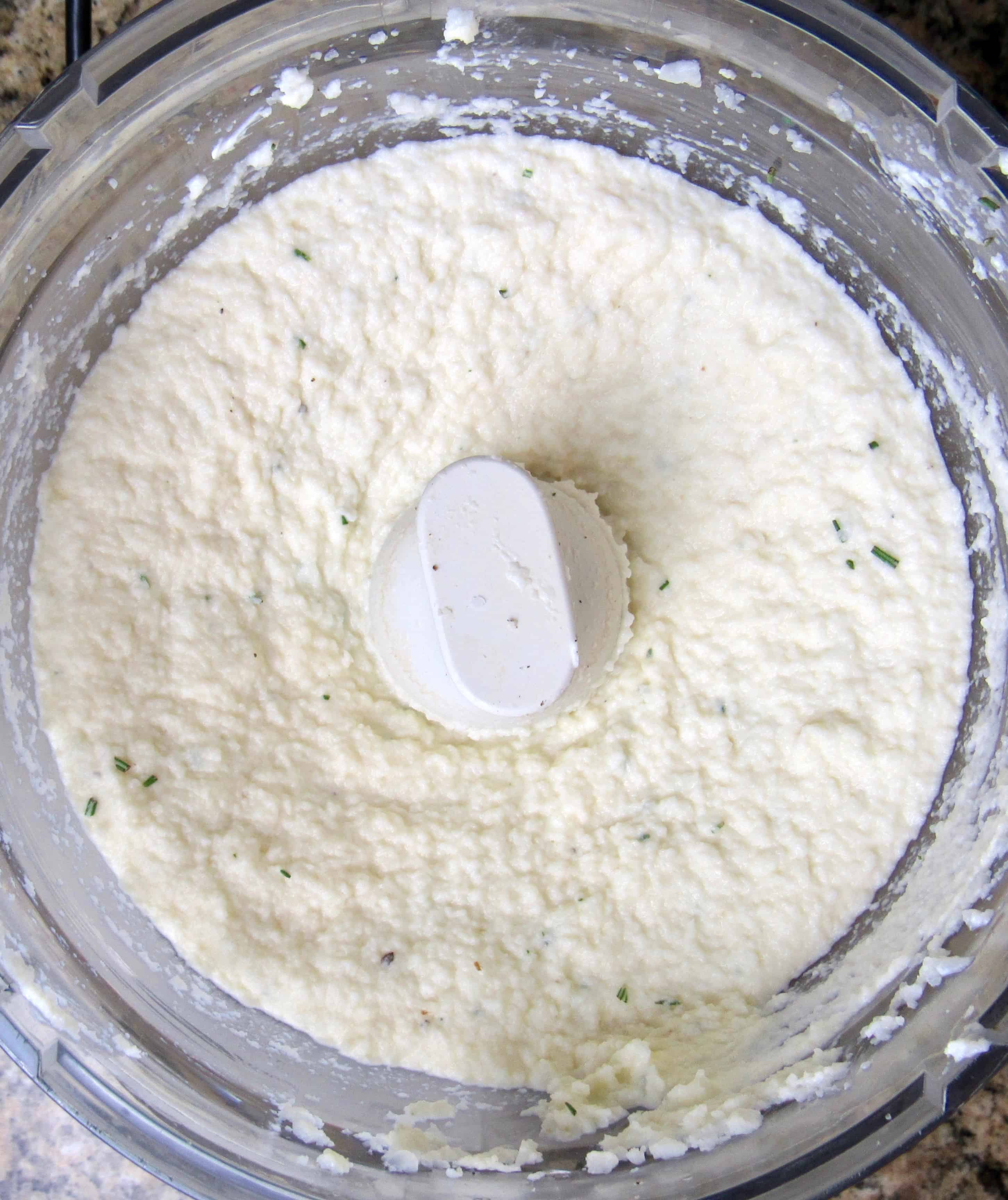 mashed cauliflower in bowl of food processor