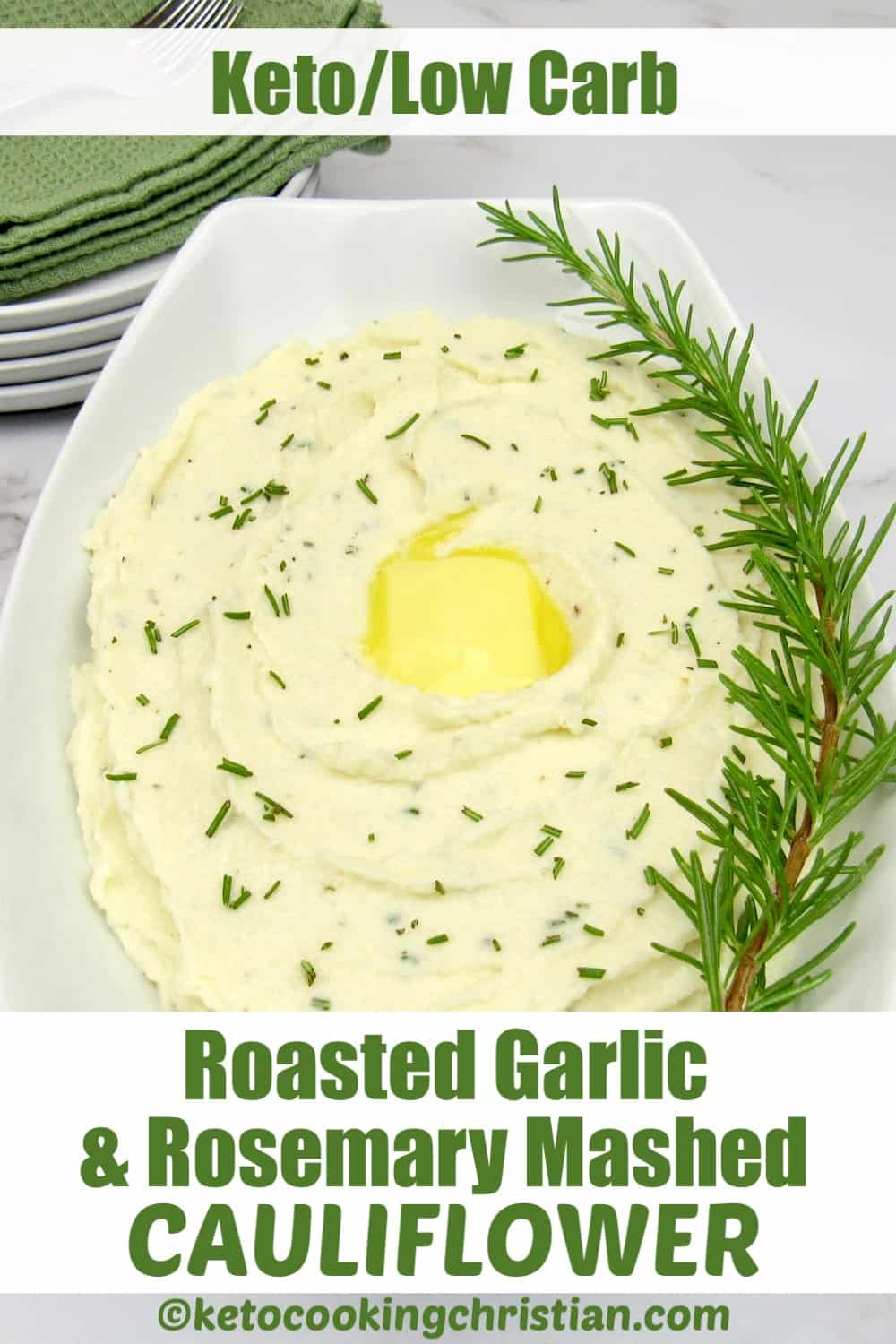 mashed cauliflower in white bowl with pat of butter in center and rosemary sprig