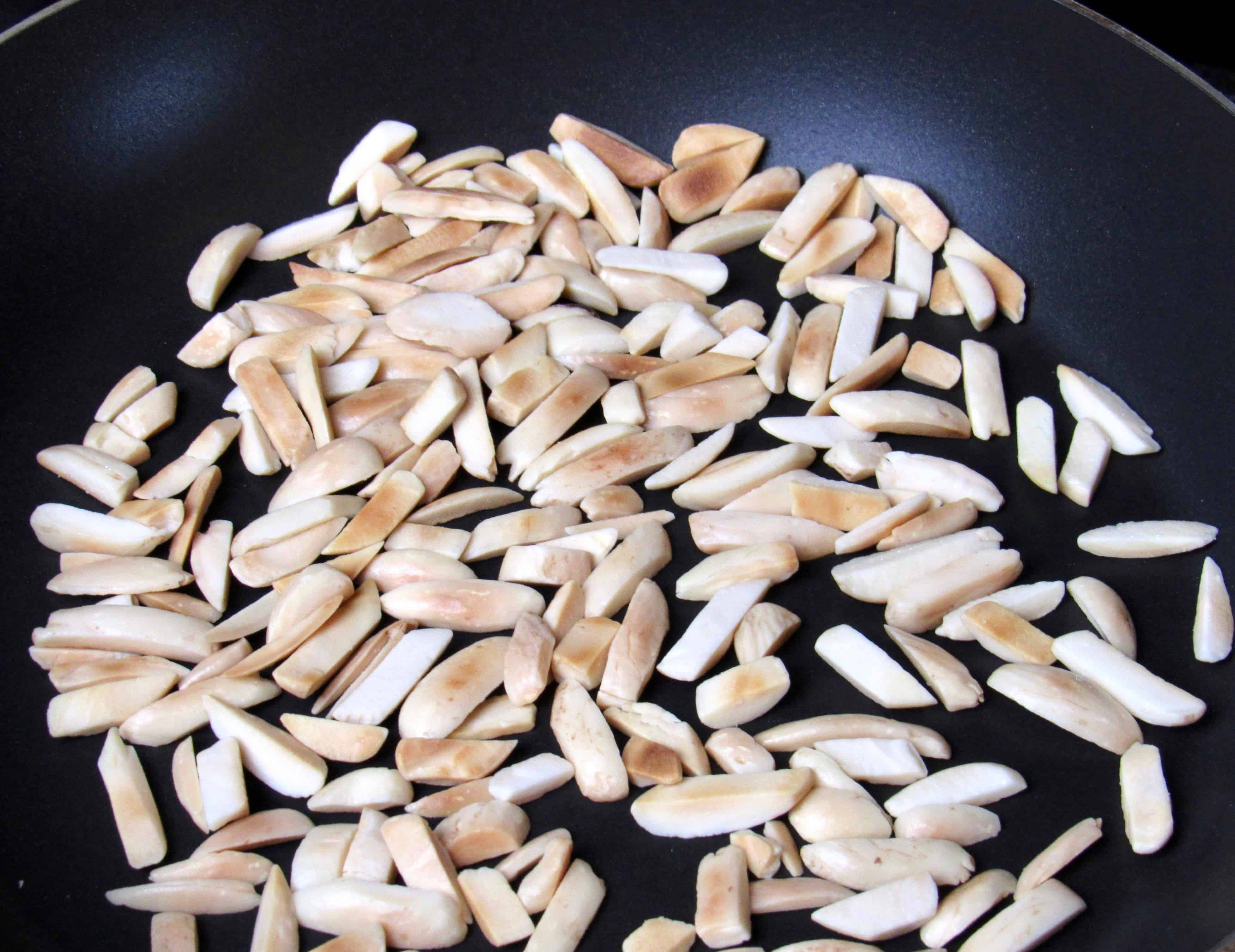 slivered almonds in skillet toasting