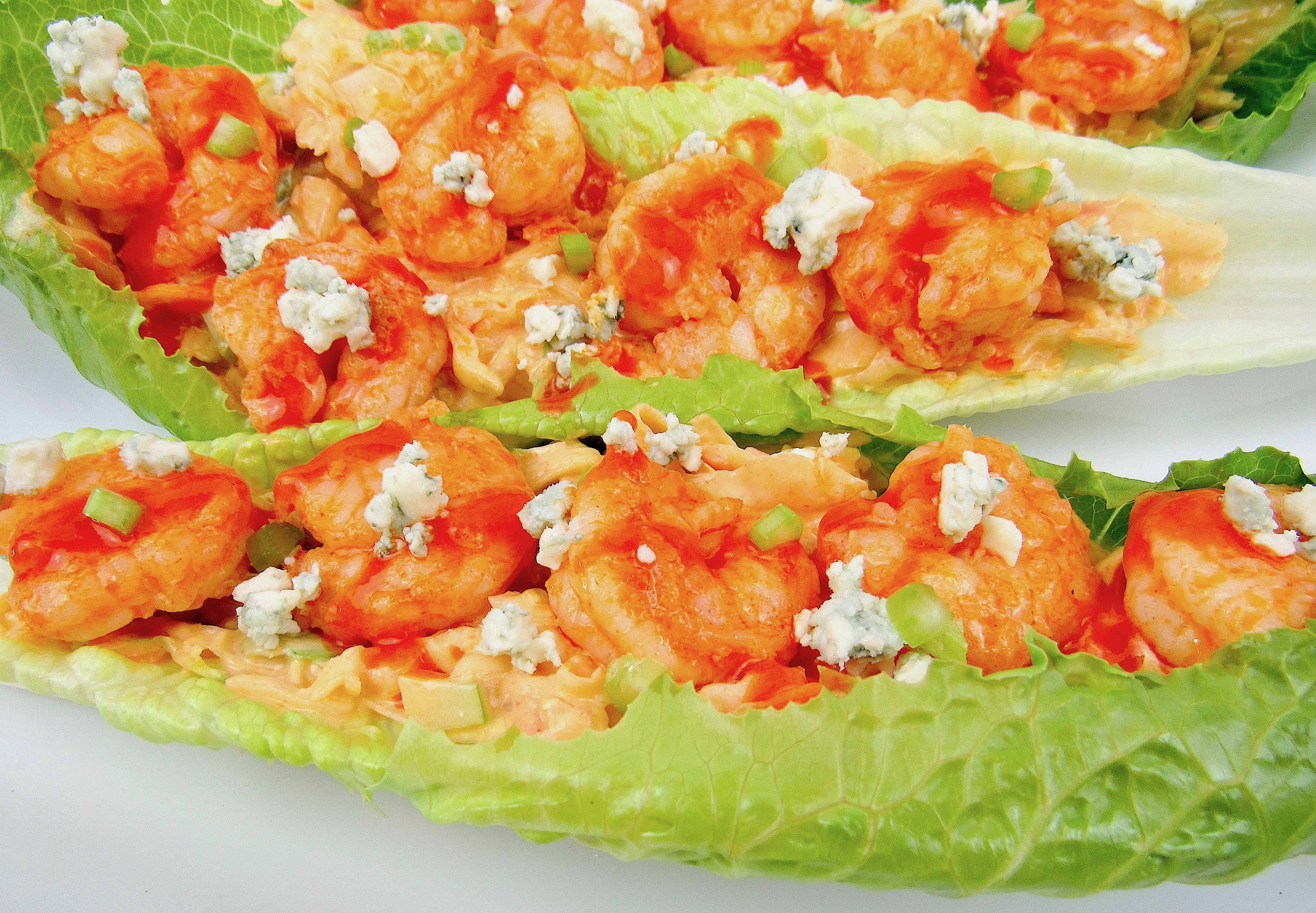 buffalo shrimp in lettuce wraps with blue cheese crumbles