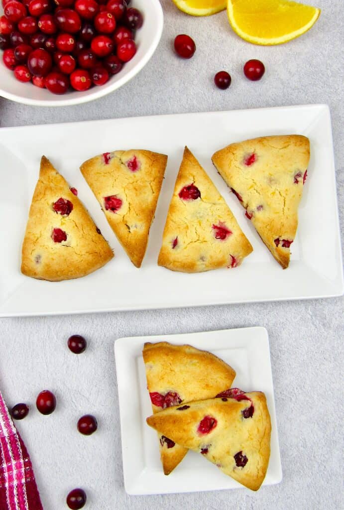 overhead view of cranberry scones on white plates