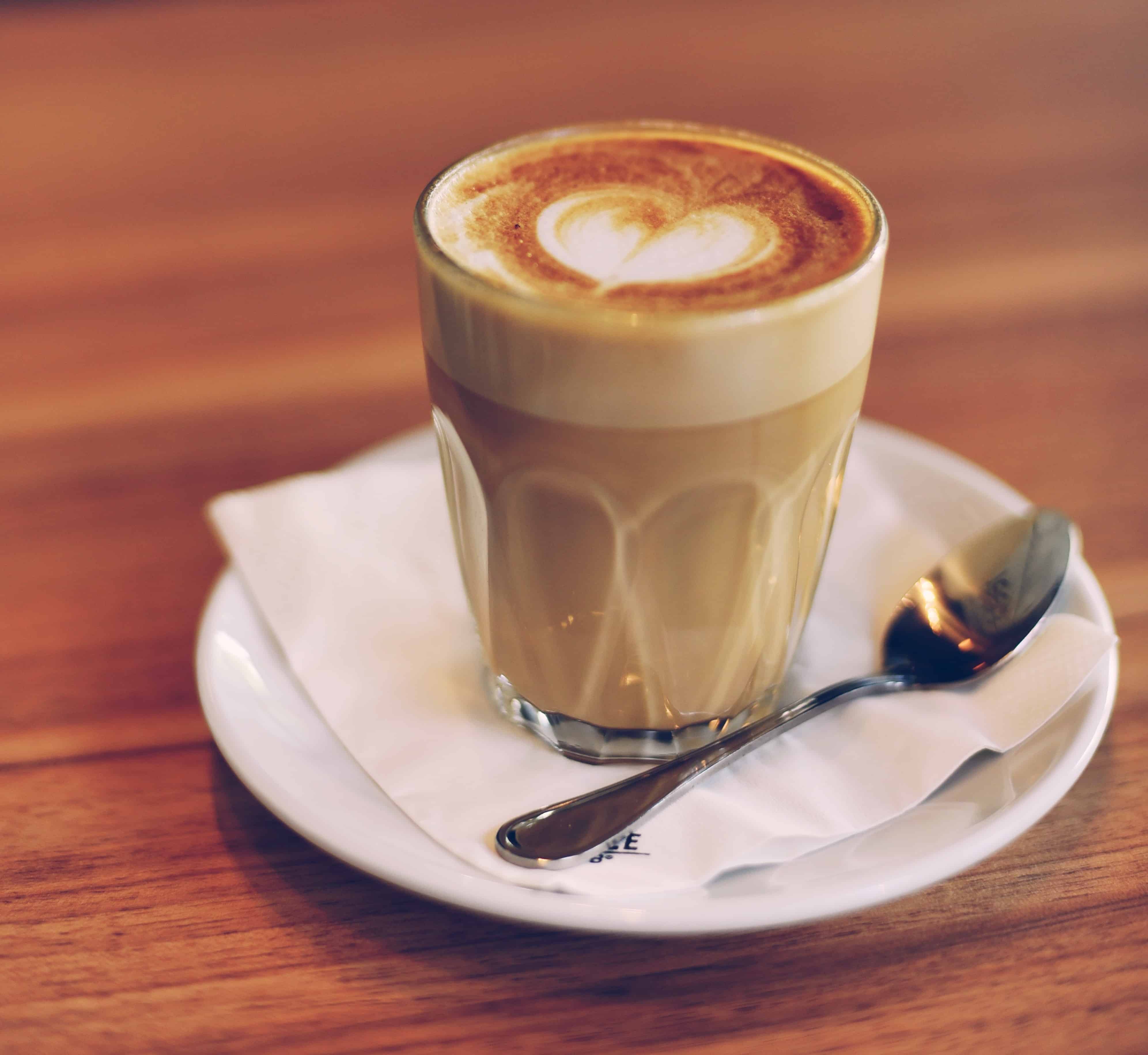 coffee with cream on saucer with spoon