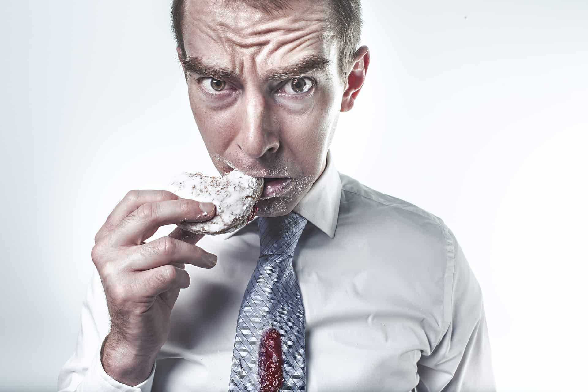 man eating powdered donut