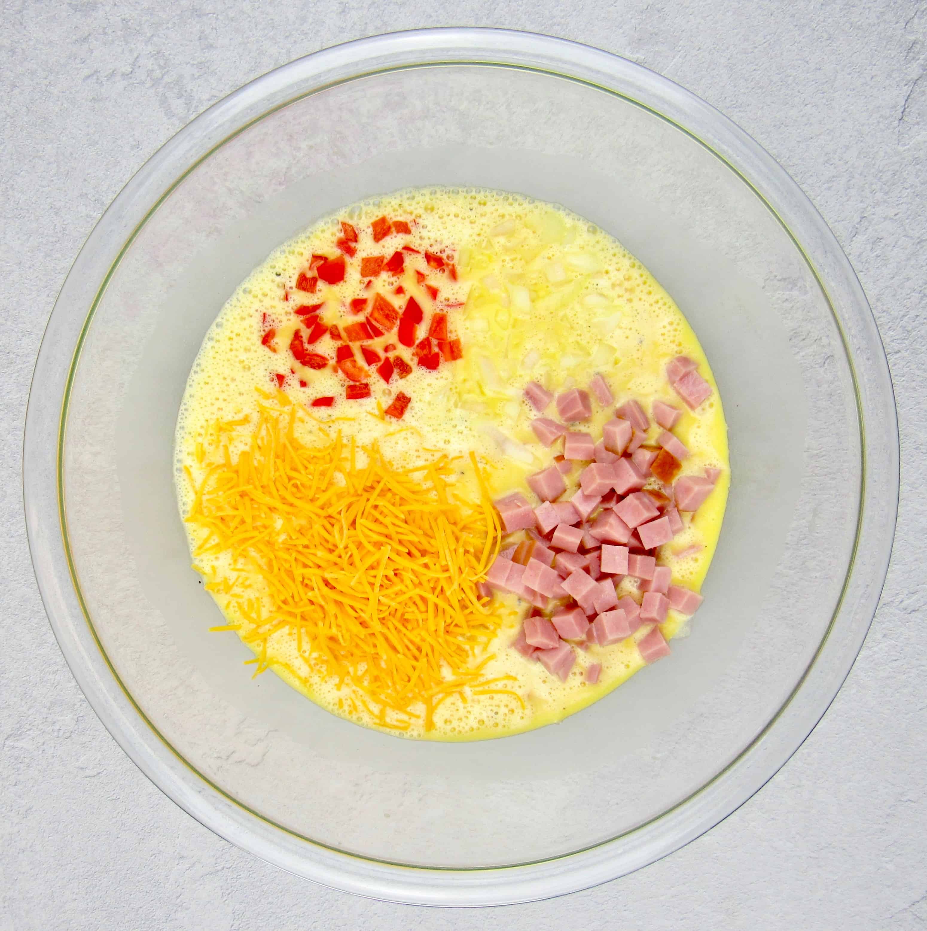breakfast casserole egg mixture is glass mixing bowl