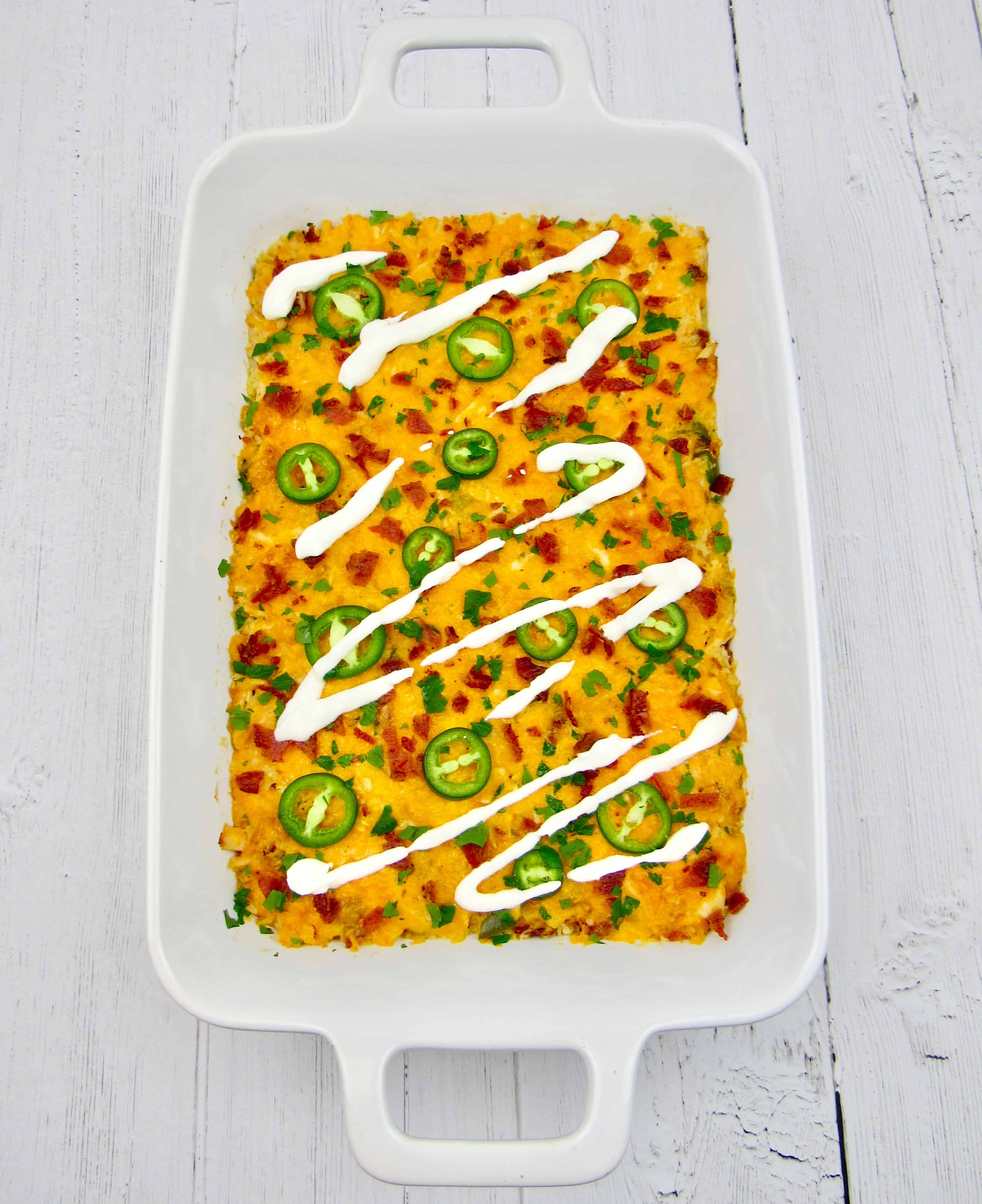 overhead view of jalapeno popper casserole with sour cream on top