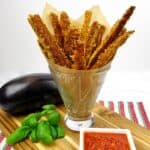 eggplant fries in glass with marinara and basil on side