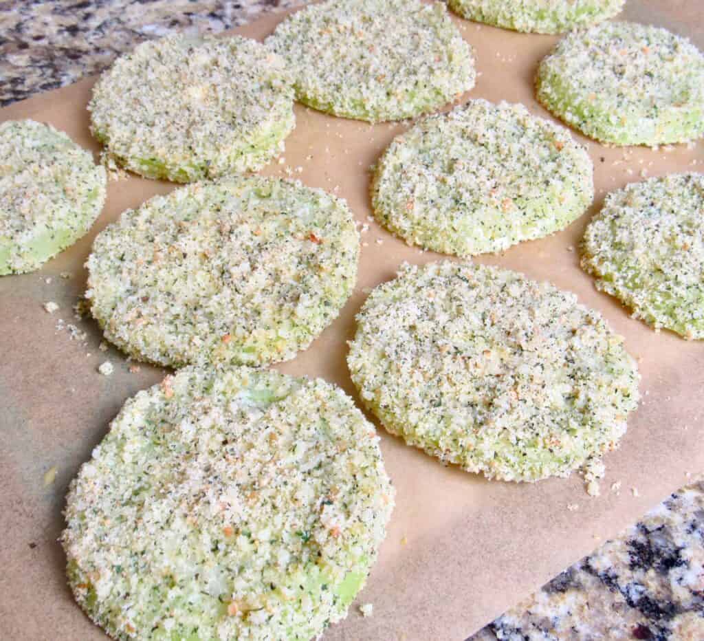breaded green tomatoes on parchment paper
