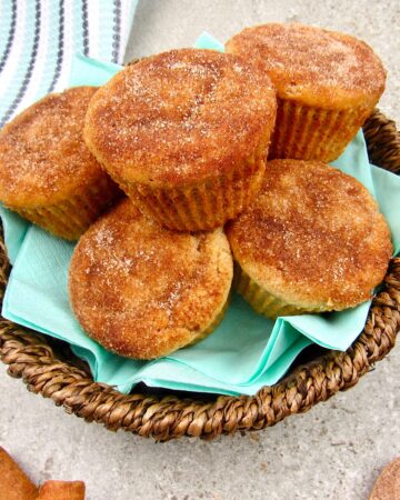 closeup overhead view of snickerdoodle muffins in a brown basket