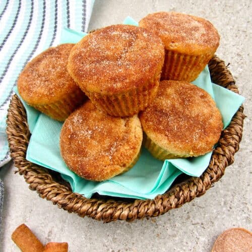 closeup overhead view of snickerdoodle muffins in a brown basket