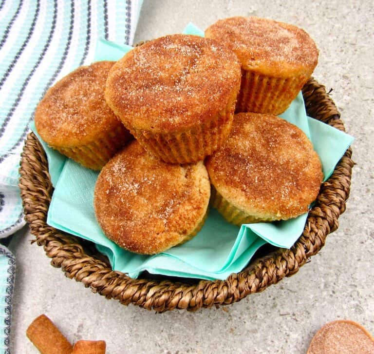 closeup overhead view of snickerdoodle muffins in a brown basket