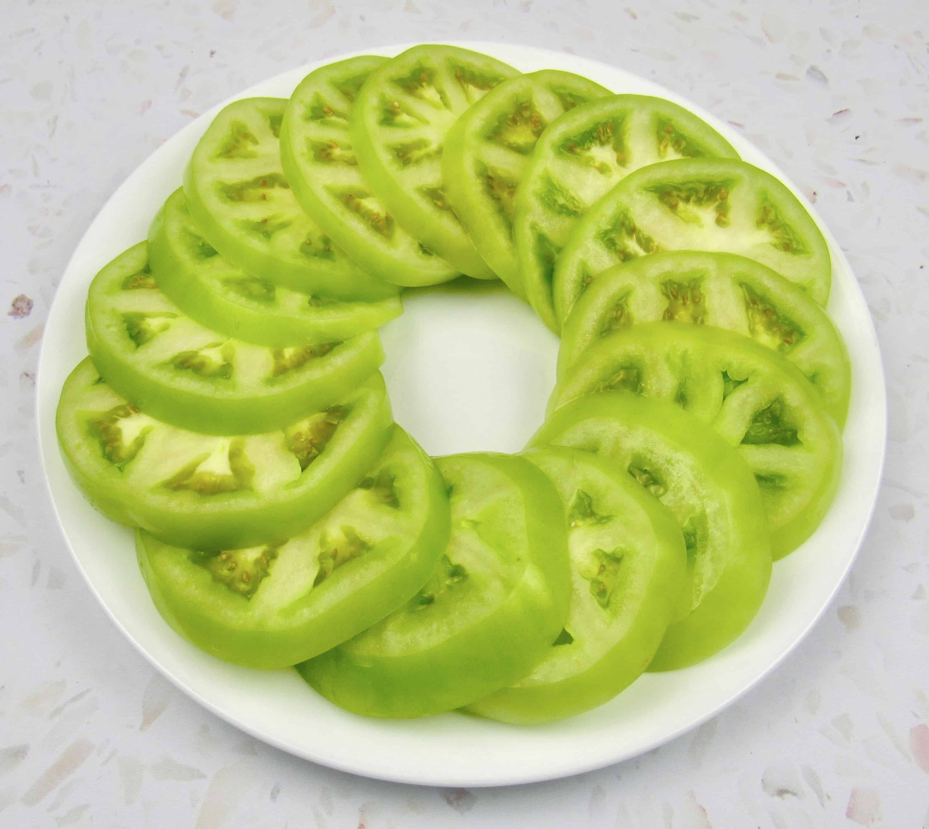 green tomatoes sliced on white plate