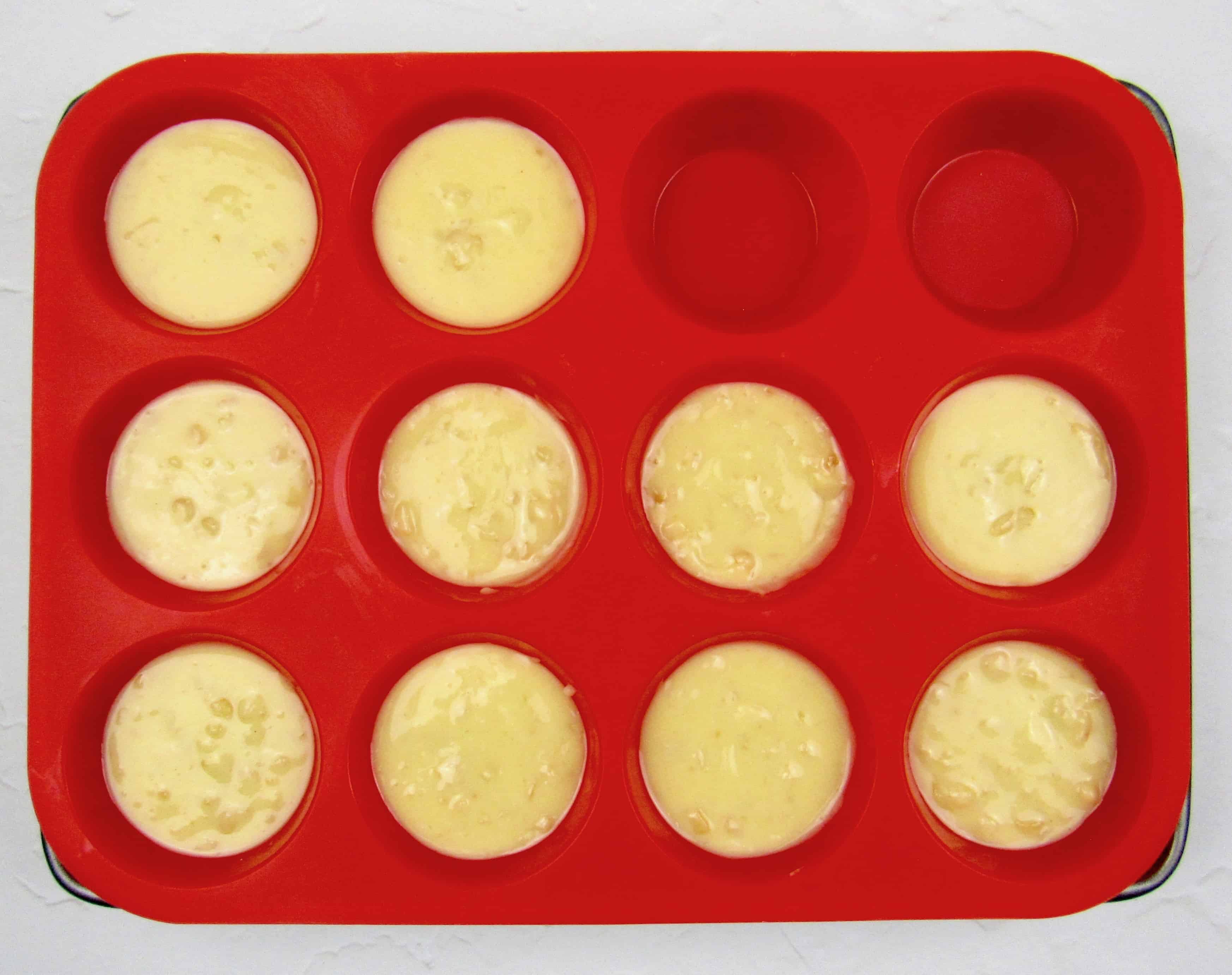 white chocolate nut fat bombs in red silicone muffin pan