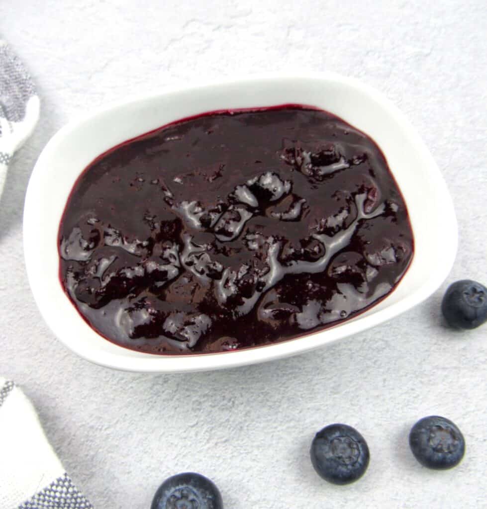 overhead view of blueberry sauce in white bowl