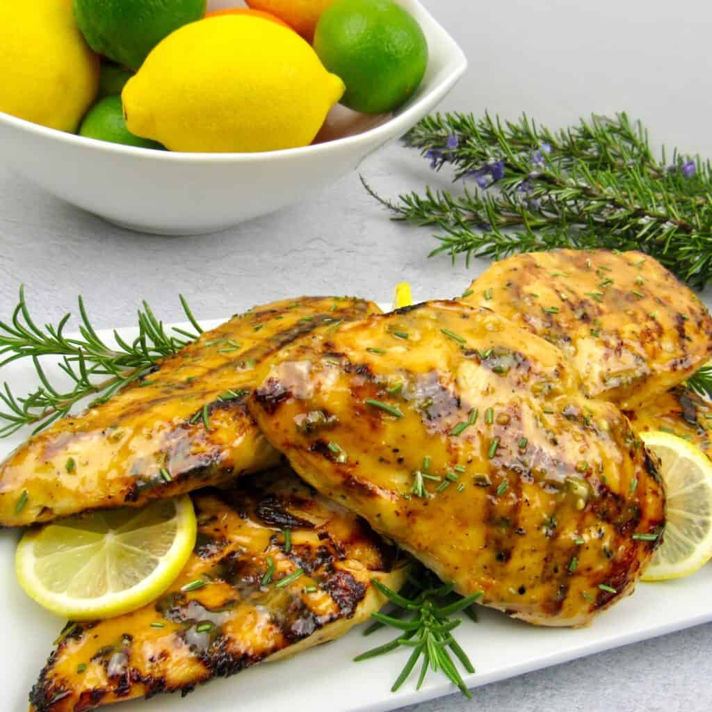 grilled citrus chicken with fruit in background