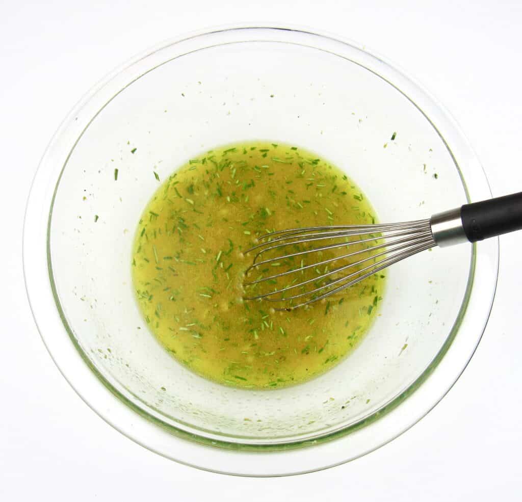 citrus marinade in glass bowl with whisk