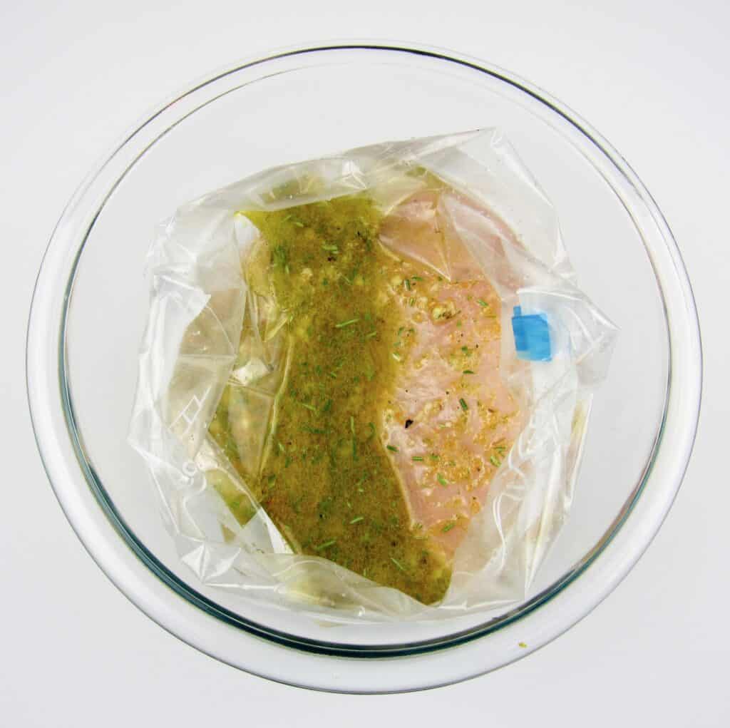 chicken breast with marinade in baggie