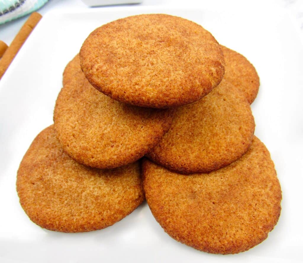 closeup of snickerdoodle cookies stacked on white plate